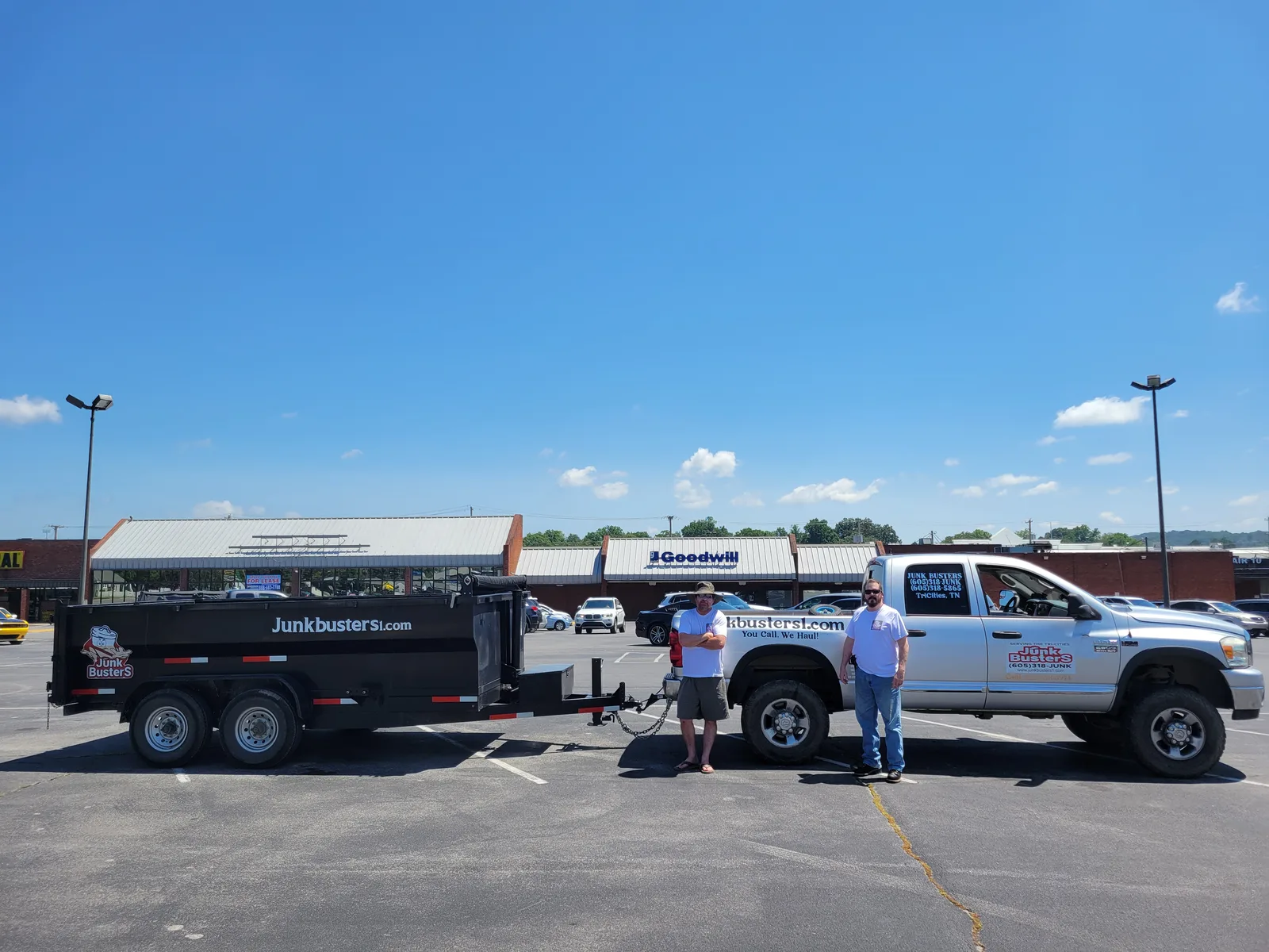 The Junk Busters crew with their branded truck and dump trailer outside Goodwill in the Tri-Cities, TN